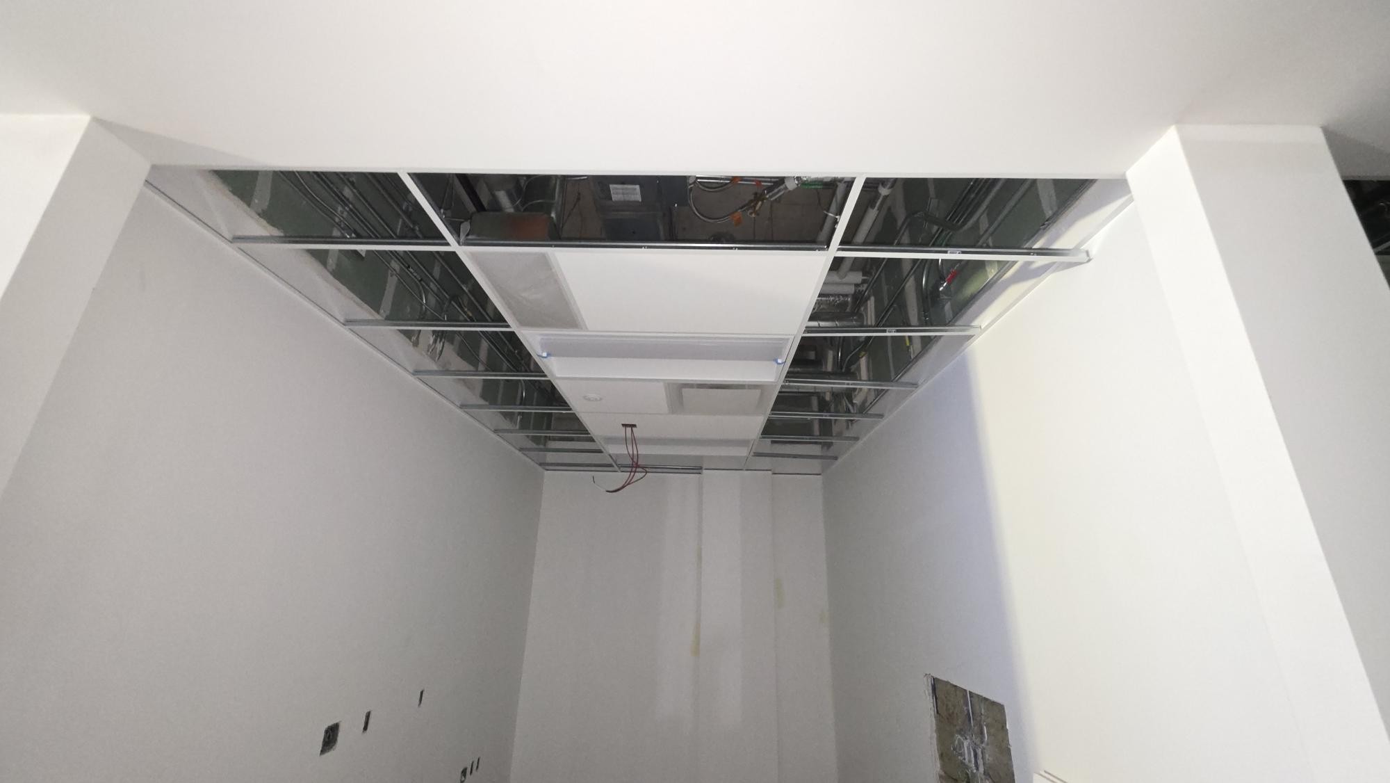 Selected white panels within a smaller room’s grid; adjacent bays remain open.