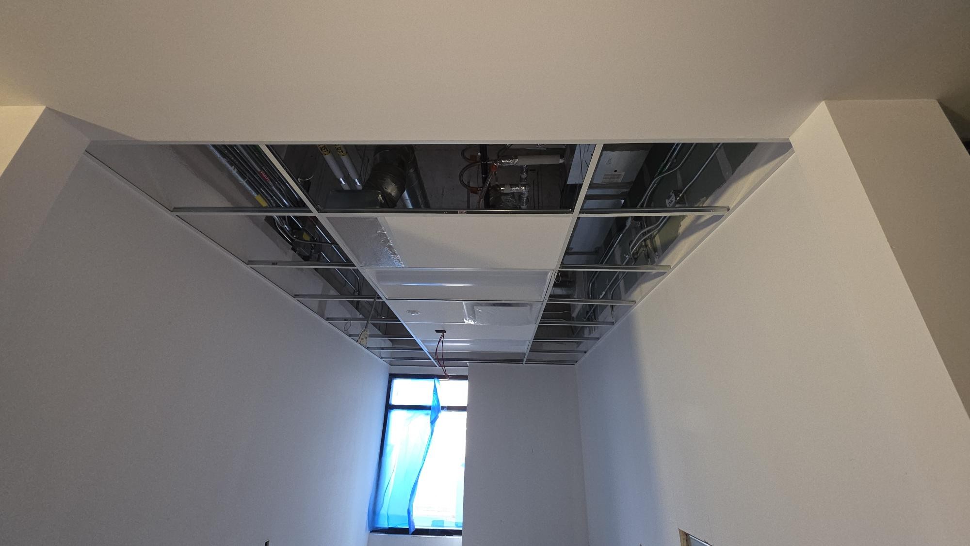 The smaller room photographed toward a daylight opening makes the ceiling direction and room depth visible.