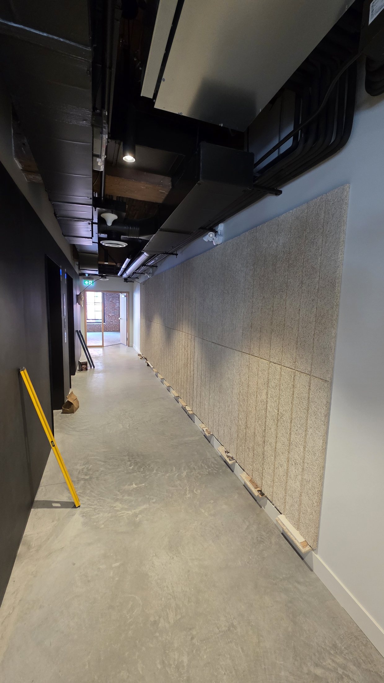 Tectum wall panel installation progressing along the Level 2 corridor