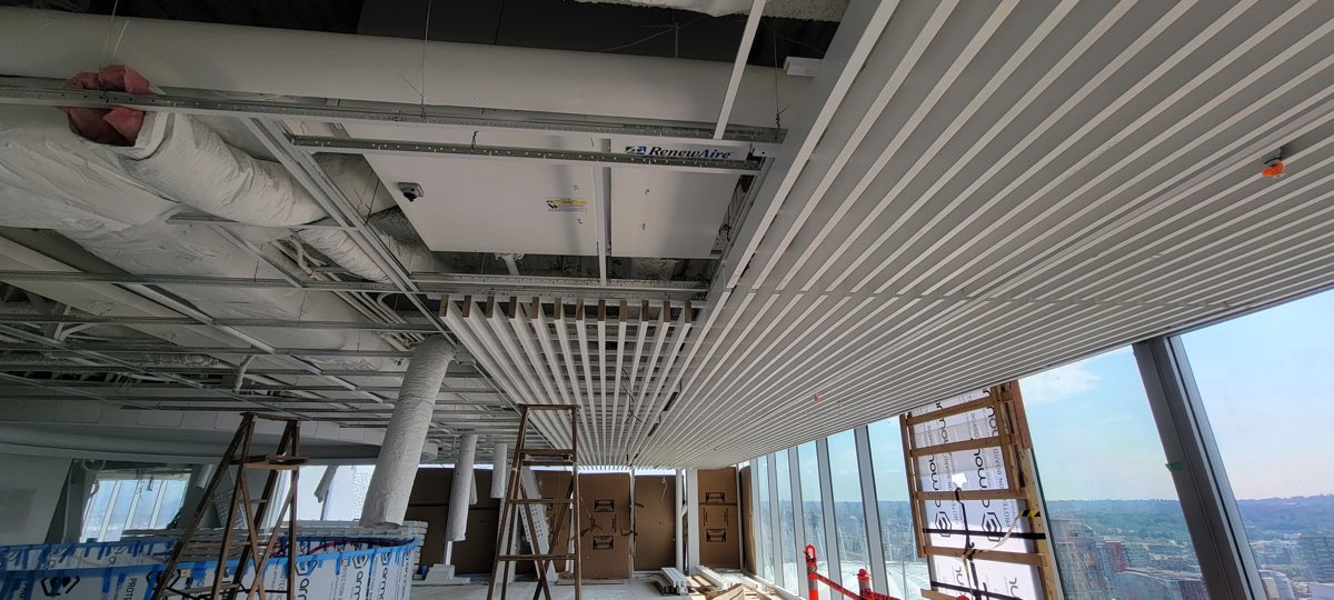Linear ceiling installation coordinated around mechanical equipment