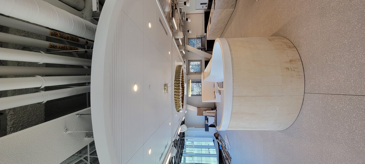 Large circular feature ceiling with integrated downlights and diffusers