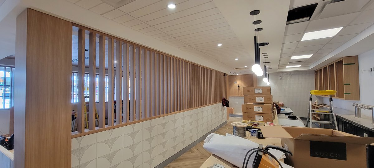 Commercial interior with wood slat screens and coordinated ceiling