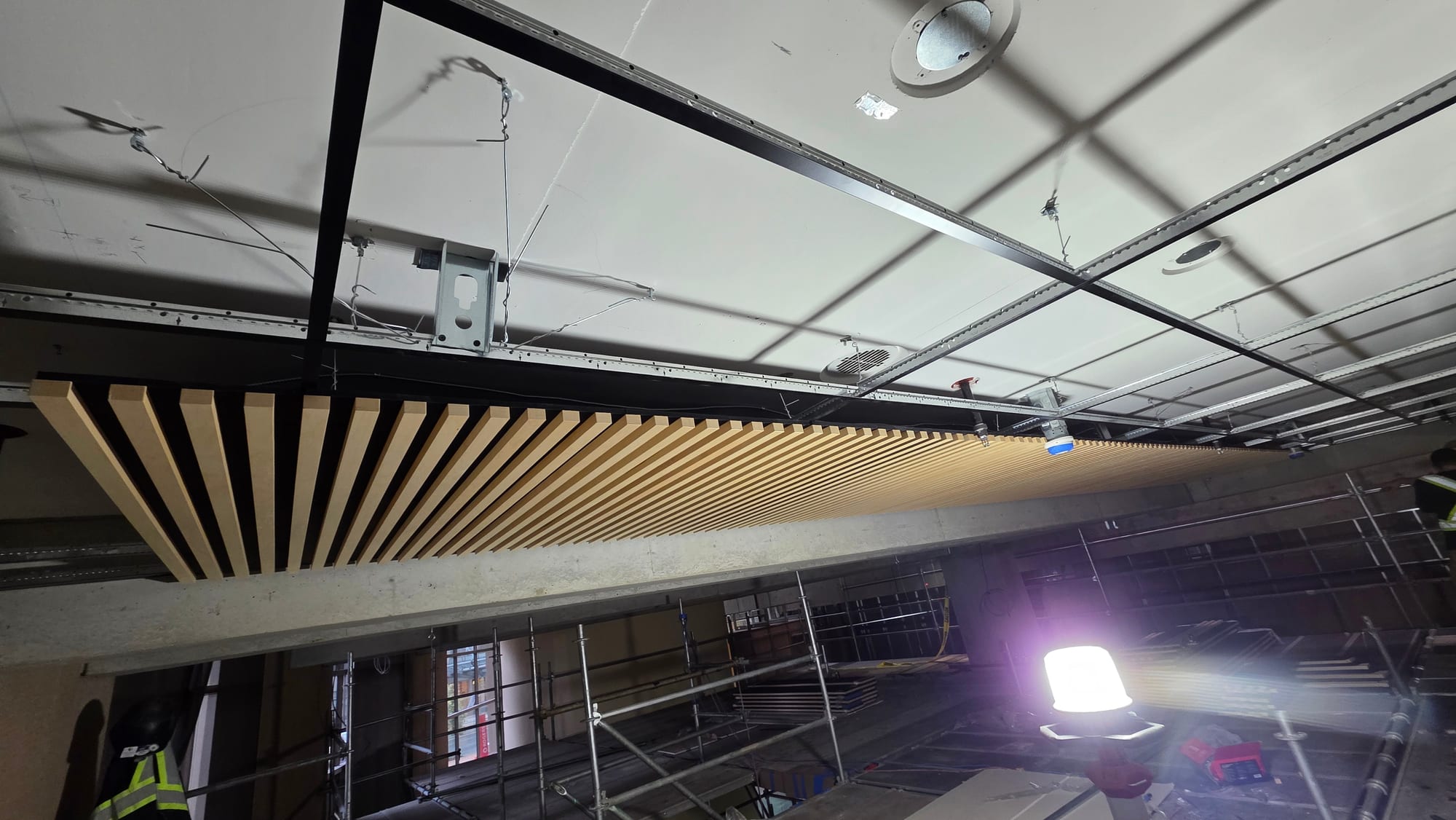 Suspended wood slat ceiling installation by Rambo Walls and Ceilings
